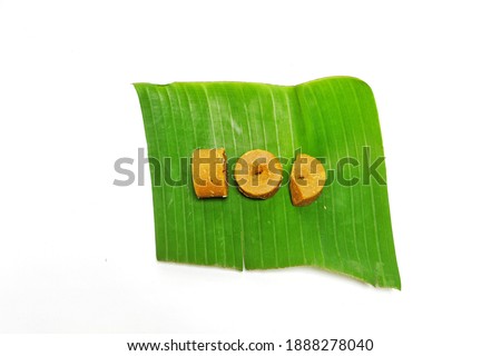 Palm sugar on banana leaf isolated on white background