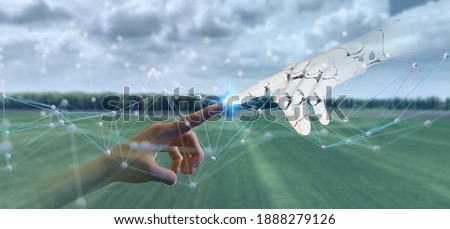 smart farming with futuristic agriculture technology concept, hand man point to robot hand together with mesh of commnuinty network with use artificial intelligence, 5g, machine learning mixed reality Royalty-Free Stock Photo #1888279126
