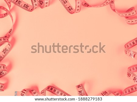 Tape measure frame on pink background