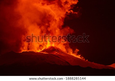Mount Etna erupts in Sicily. Volcano erupt lava into the air and lava flow.