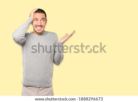 Crazy young man making a gesture of despair