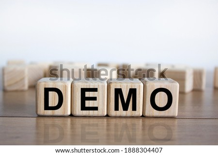 Demo symbol. Concept word 'demo' on cubes on a beautiful wooden table. White background. Business and demo concept. Copy space.