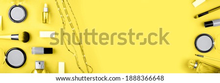 Banner made from set of decorative cosmetics for make up on yellow background. Copy space, flat lay.