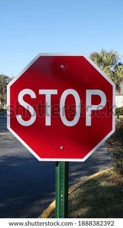 Red stop sign on the side of the road
