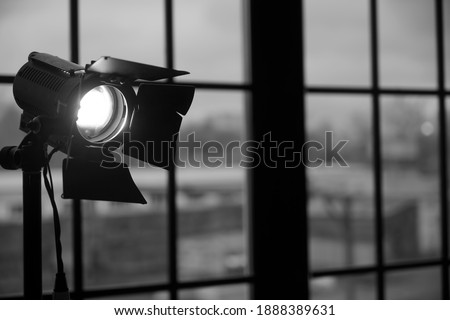 Photography studio on window background with lamp. Professional lighting equipment for video production. constant light