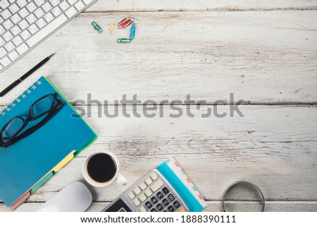 stationary and computer with coffee on the working table