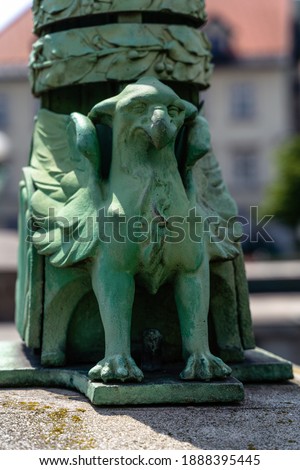 A vertical shot of an eagle sculpture in Ljubljana, Slovenia on the blurred background