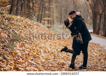 Young couple together walking in an autumn park