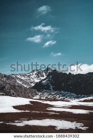 vertical snowy mountains and cloudy sky