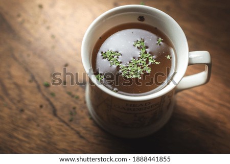 Bone broth drink in a cup on wooden table