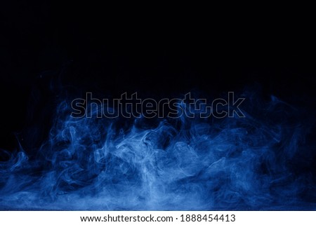 Abstract blue smoke moves on black background. Swirling smoke. Royalty-Free Stock Photo #1888454413