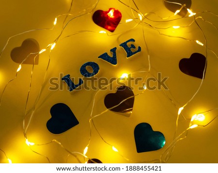 Valentine's Day Love glitter sign text on pastel yellow background hearts confetti, creative flatlay minimal concept. Greeting card top view social media sale banner design. Bright vebrant colors.