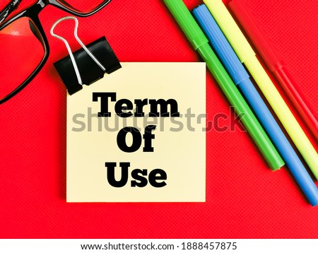 Text Term Of Use on paper note with stationery isolated on red background. Business concept. 