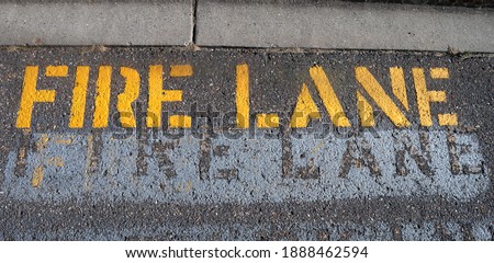 Yellow stenciled fire lane warning on the street