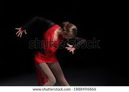 young woman figure skater on a dark background