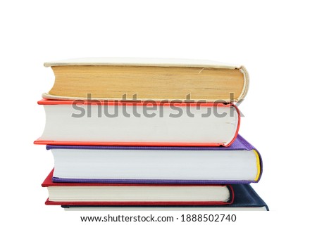 Isolated books, stacked over one another in front of a white background