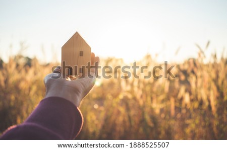 House model on hand for family home and real estate.