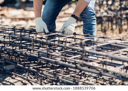 Asian construction worker on building site. fabricating steel reinforcement bar. wearing surgical face mask during coronavirus and flu outbreak Royalty-Free Stock Photo #1888539706