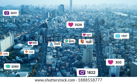 Notice balloons of social networking service pop-up above modern city. Social media. Royalty-Free Stock Photo #1888558777
