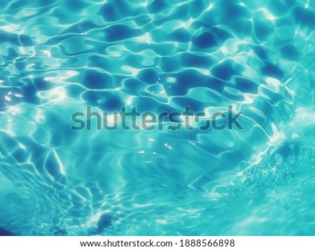 Closeup abstract of surface blue water for background. Blurred abstract for background. Water splash for background. Reflection on surface blue water in the sea.