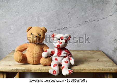 Two teddy bears, an old wooden table suitable for presentations.