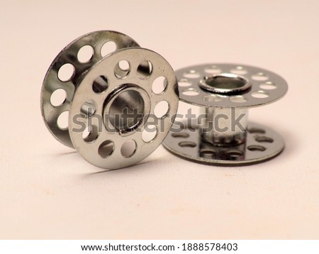 Picture of metal bobbins, used for winding thread that using on sewing machine
