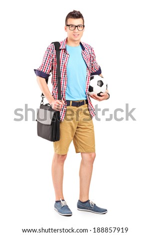 Full length portrait of a man holding a bag and football isolated on white background