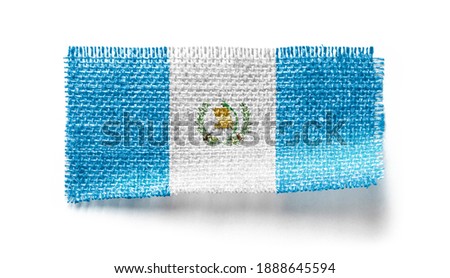 Guatemala flag on a piece of cloth on a white background