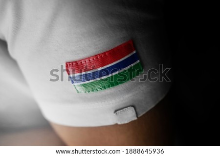 Patch of the national flag of the Gambia on a white t-shirt