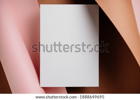 Stylish white blank paper mockup on a colorful background. Document and presentation stationery creator. Selective focus on paper