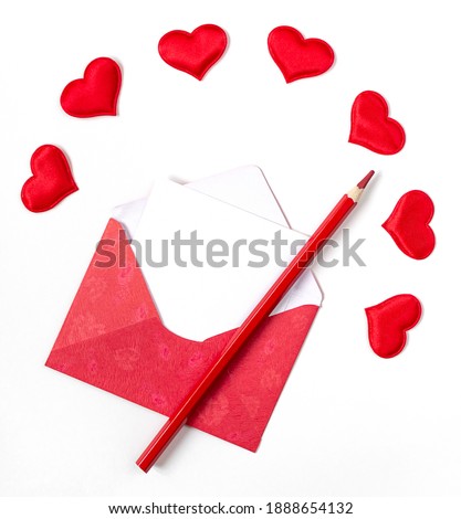 red envelope and pencil with red hearts on white background with copy space.