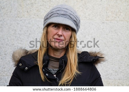 portrait of smiling woman with hat in winter
