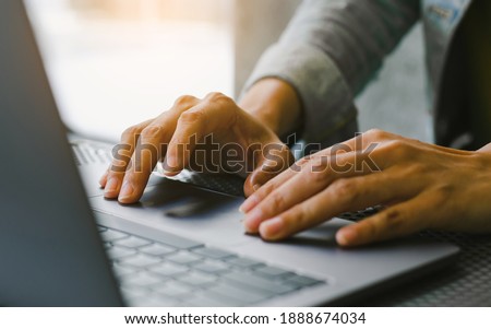 man work using computer hand typing laptop keyboard contact us online chatting search form internet sitting at office.concept for technology device communication business Royalty-Free Stock Photo #1888674034