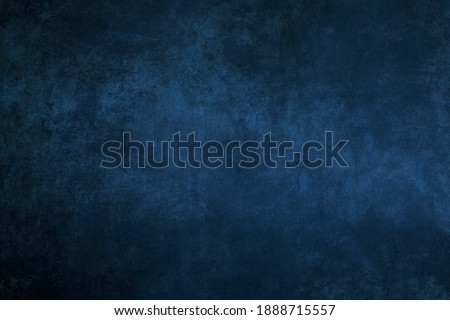 Dark blue stucco wall grungy background or texture 