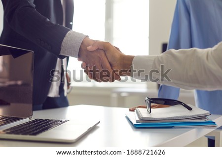 Close-up handshake between business partners. Businessman and client shaking hands, confirming deal after successful negotiation. Cooperation, partnership, trust, mutual benefit and gratitude concepts Royalty-Free Stock Photo #1888721626