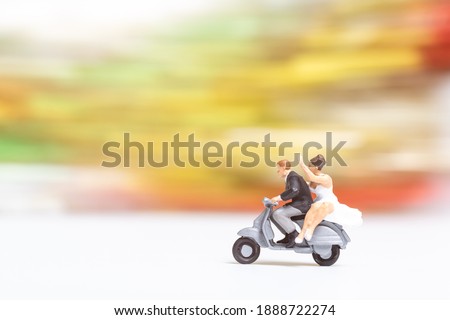 Miniature people : Couple in love riding a motorbike , Adventure and vacations concept.
