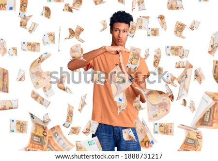 Young african american man wearing casual clothes doing time out gesture with hands, frustrated and serious face