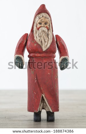 Antique wooden santa on wooden table