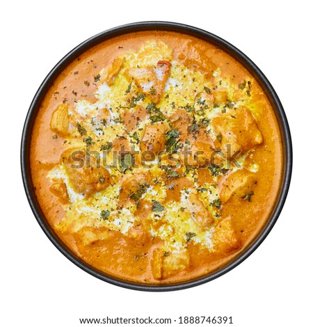 Murgh Makhani or Butter Chicken in black bowl on dark slate table top. Indian Cuisine dish with chicken meat and creamy masala. Asian food and meal. Top view Royalty-Free Stock Photo #1888746391
