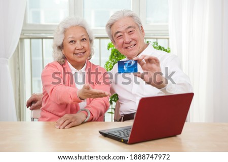 An old senior couple holding credit card high quality photo 
