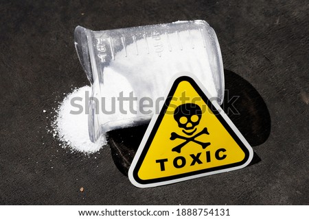 white toxic powder on a black background. a handful of toxic powder. toxic washing powder Royalty-Free Stock Photo #1888754131