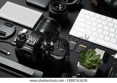 Camera, computer keyboard and video production equipment on black background