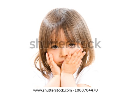 Two years old girl with hands in front the face on white background.