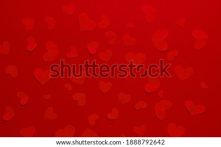 Many red hearts on a red background. Festive background. Background for design. Top view. St. Valentina.