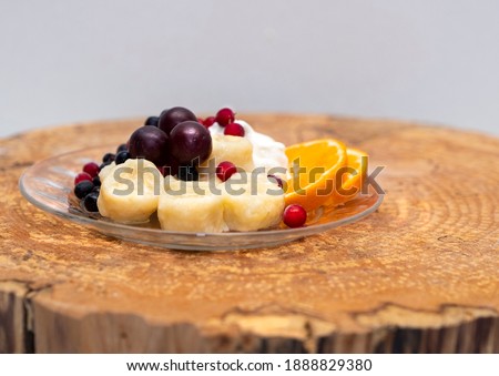 Russian kitchen. Lazy dumplings with sour cream, berries and fruits.