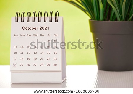 White October 2021 calendar with green backgrounds and potted plant. 2021 New Year Concept Royalty-Free Stock Photo #1888835980