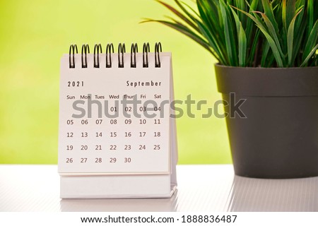 White September 2021 calendar with green backgrounds and potted plant. 2021 New Year Concept Royalty-Free Stock Photo #1888836487