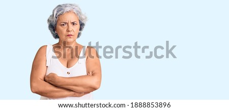Senior woman with gray hair wearing casual clothes skeptic and nervous, disapproving expression on face with crossed arms. negative person.  Royalty-Free Stock Photo #1888853896