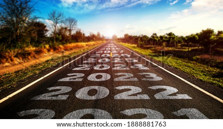 2021-2025 written on highway road in the middle of empty asphalt road and beautiful blue sky. Concept for vision 2021-2025. Royalty-Free Stock Photo #1888881763