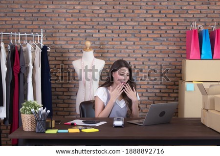 Young business woman working selling online. Surprise and shock face of asian woman success on making big sale of his online store. Online shopping